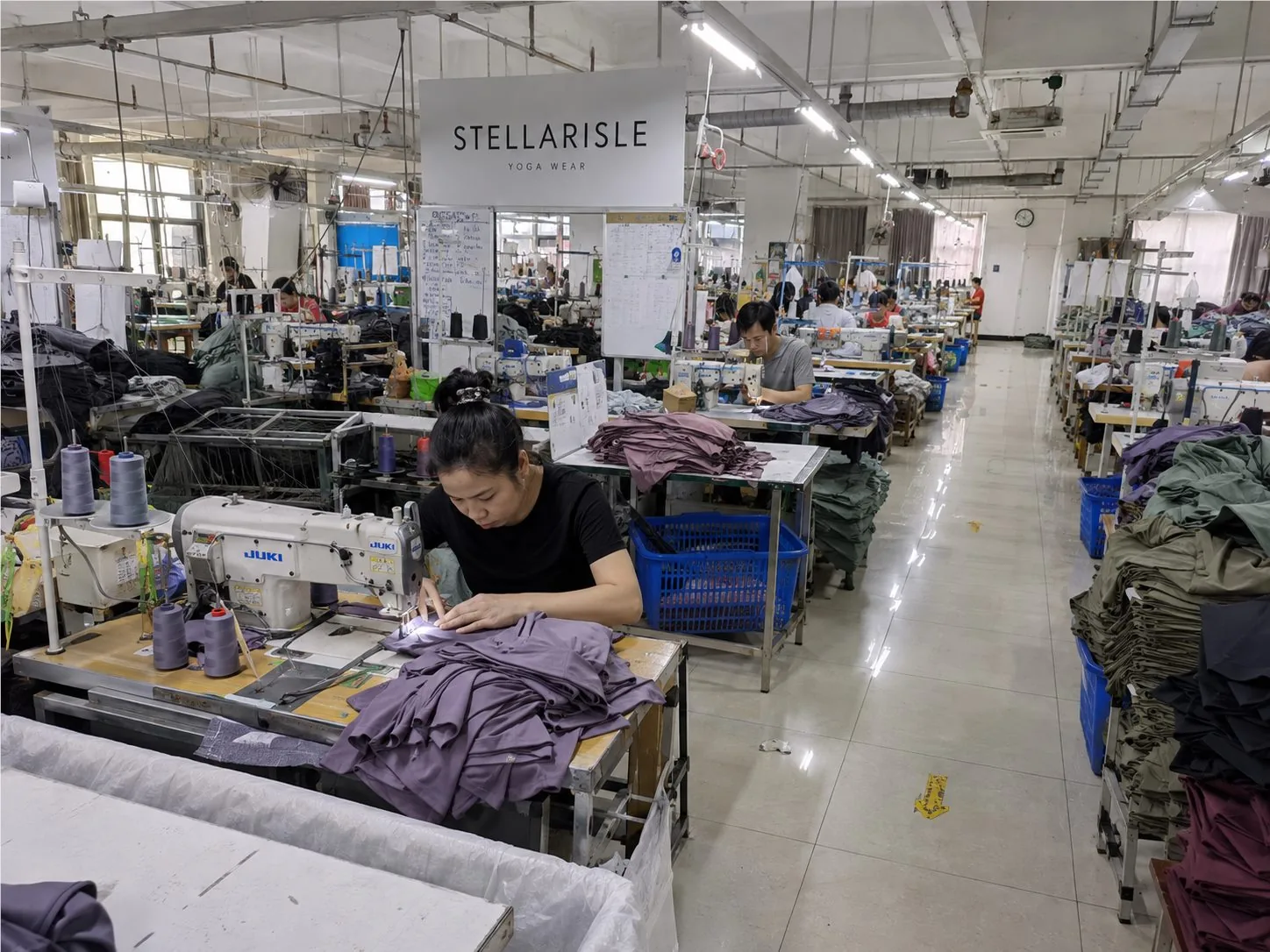 Stellarisle activewear sewing workshop with production tables and bulk yoga wear orders